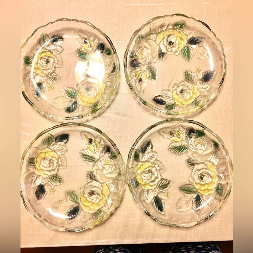 A set of four glass fruit bowls with engraved designs and dull polish